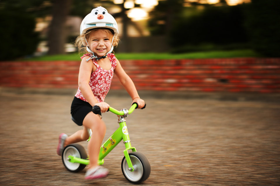 Child learning to ride a bike